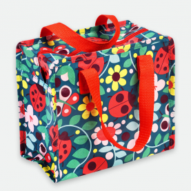 sac repas avec fond bleu marine, motifs coccinelles et fleurs avec des anses rouges